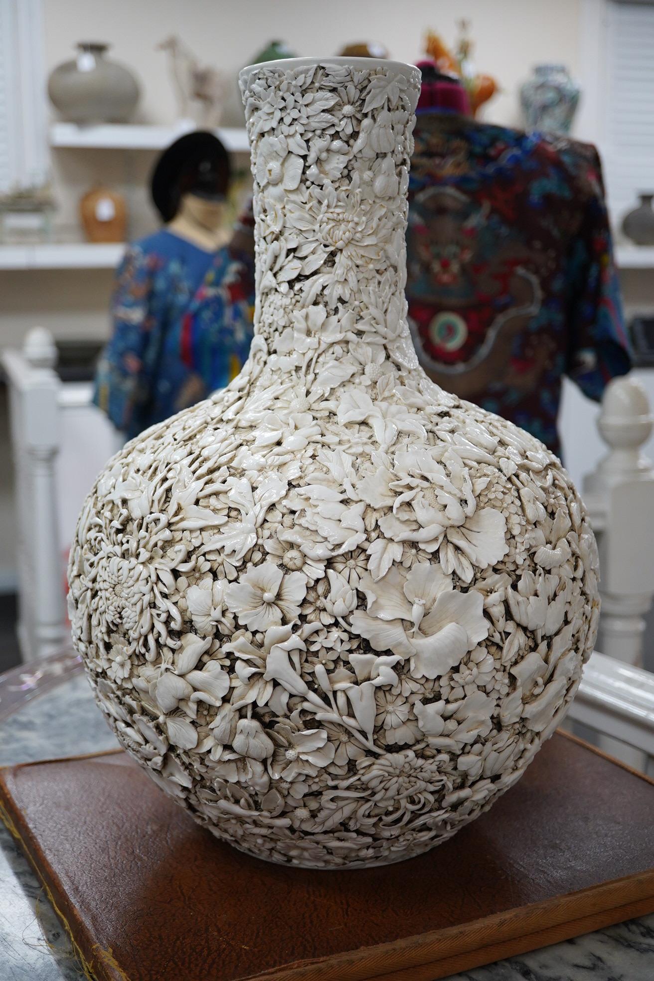 A large Chinese carved porcelain ‘thousand flower’ bottle vase, 20th century